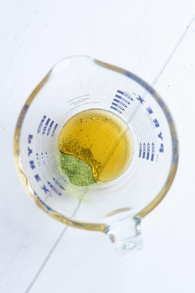 A bowl of matcha and honey.
