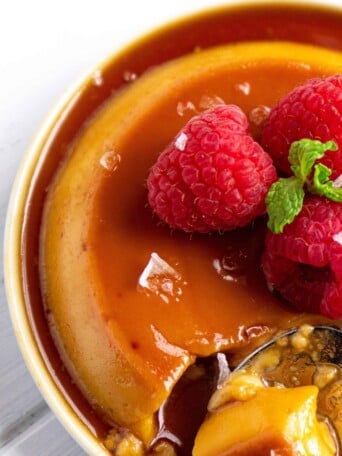 Puerto Rican Salted Coconut Flan on small plates with raspberries.