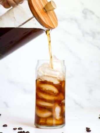 A French press pouring Overnight Cold Brew Coffee.
