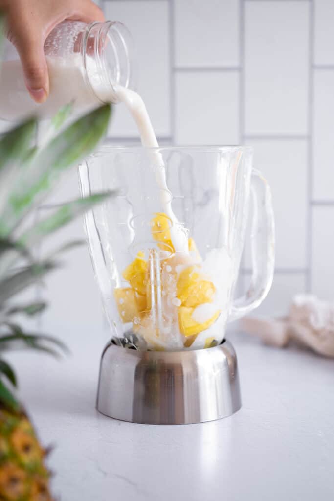 coconut milk pouring into a blender