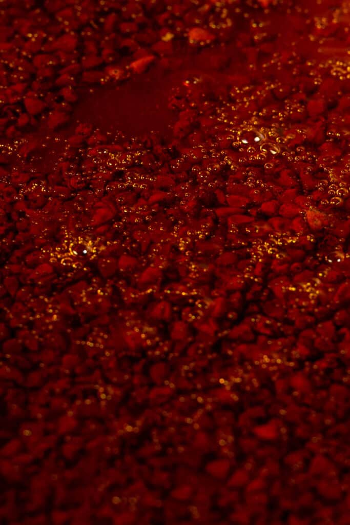 Annatto seeds simmering in oil