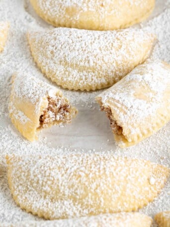 gazelle horn cookies on a sugar dusted pan