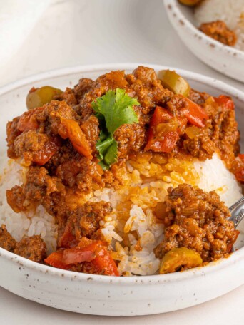 picadillo in bowls on a white table