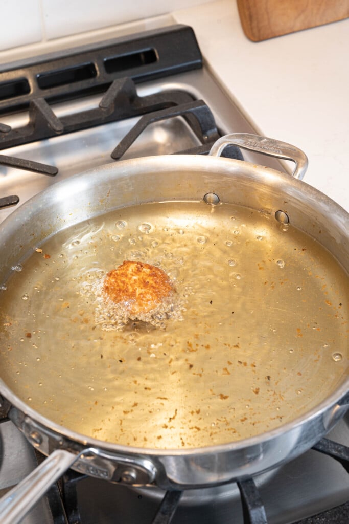 a croqueta frying in oil