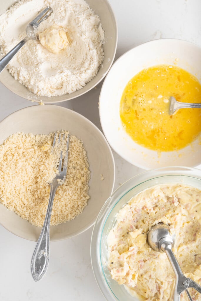 bowls of flour, breadcrumbs, eggs, and more