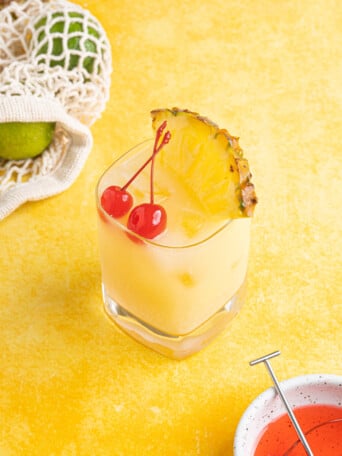 a piña colada on the rocks on a yellow counter