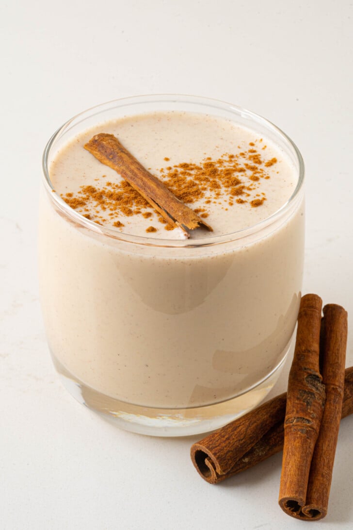 a glass of coquito on a counter