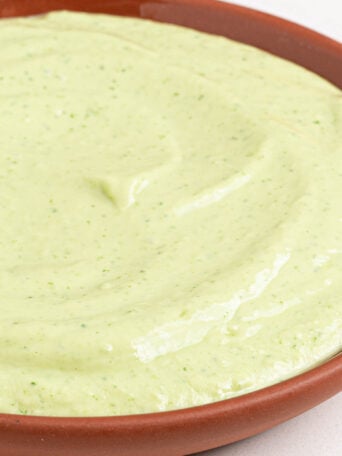 A bowl of creamy avocado dip.