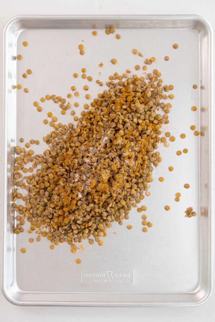 Dal with spices on a baking sheet.
