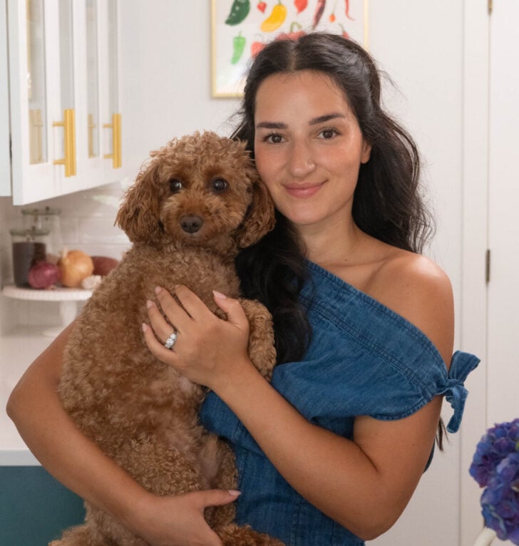 Salima and her dog Mac in her kitchen.