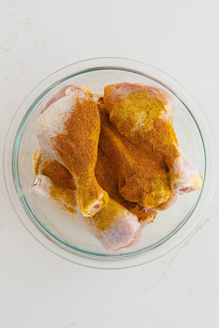 A bowl of chicken with sazon and adobo.