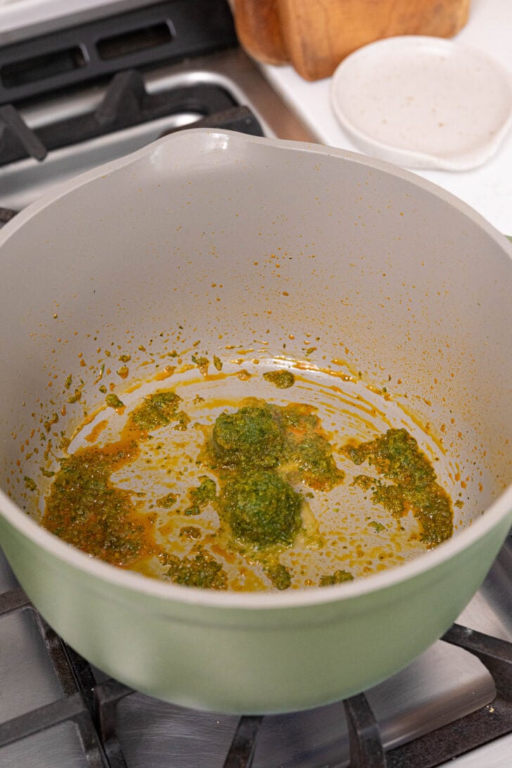 A pot with sofrito simmering in oil.