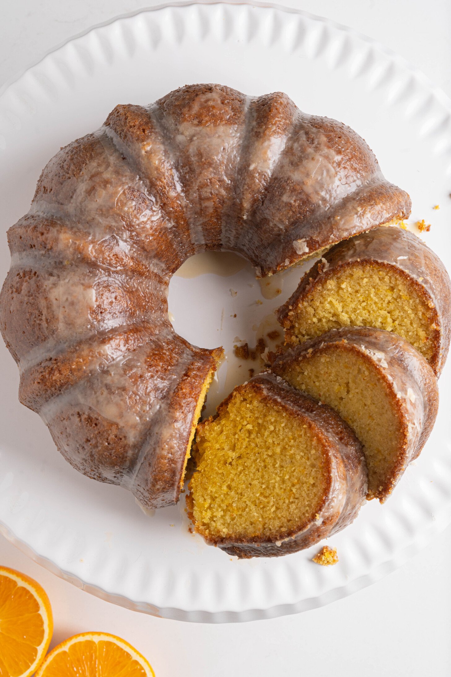 Orange bundt cake on a tray.
