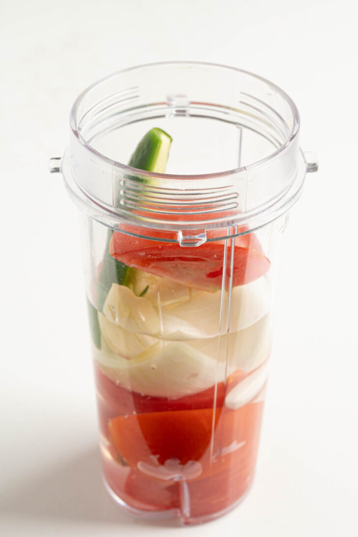 Tomatoes, onions, and more in a blender.