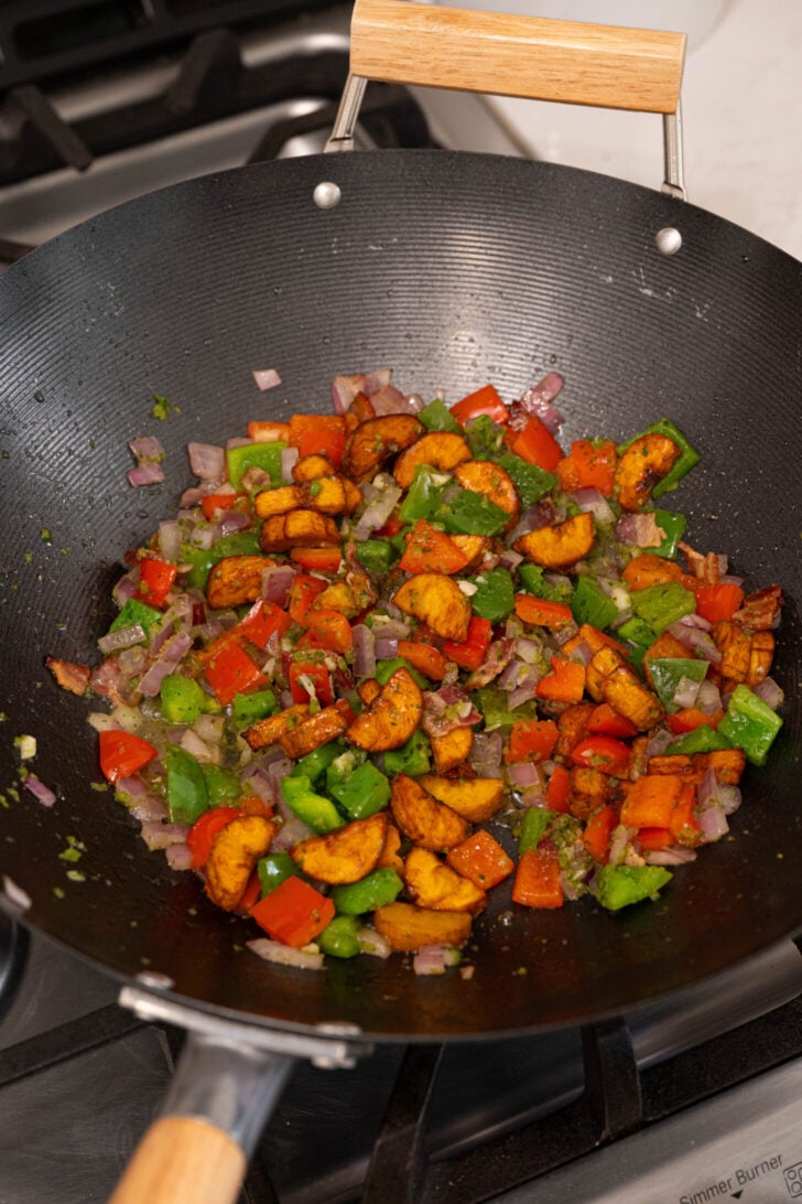 Vegetables frying in a wok.