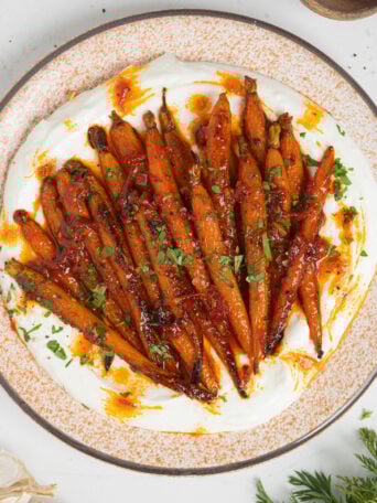 Harissa honey roasted carrots on a plate.