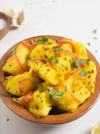 Yuca with garlic sauce in a bowl.