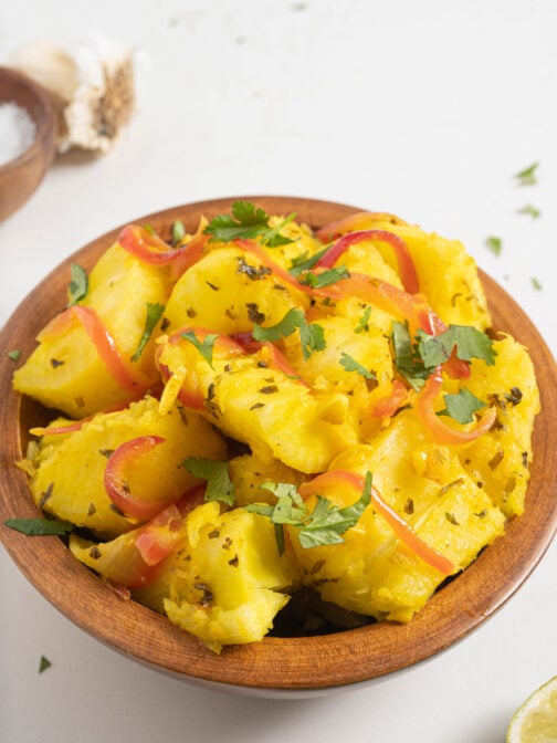 Yuca with garlic sauce in a bowl.