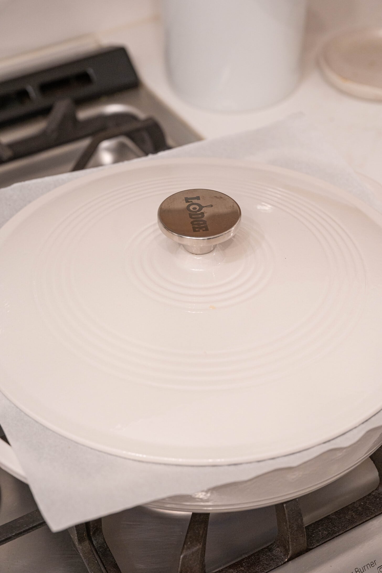 A dutch oven with parchment paper lid.