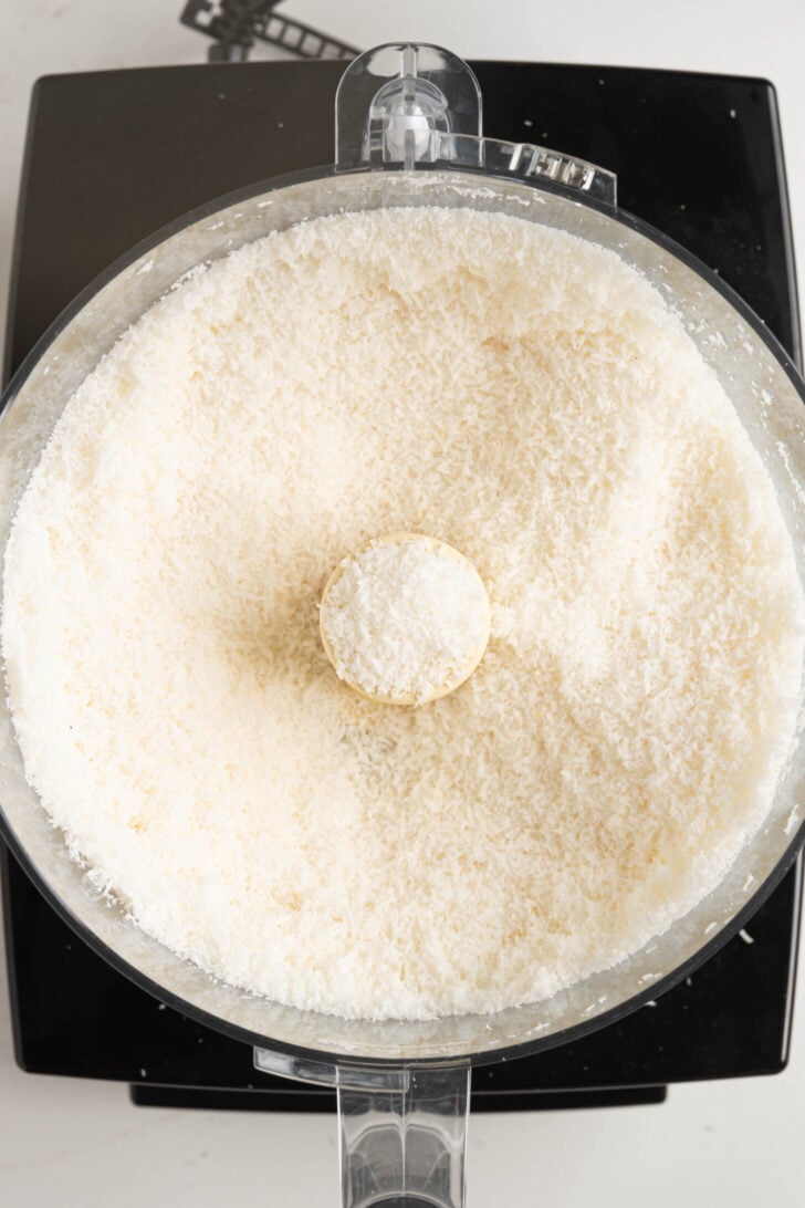 Shredded coconut in a food processor.