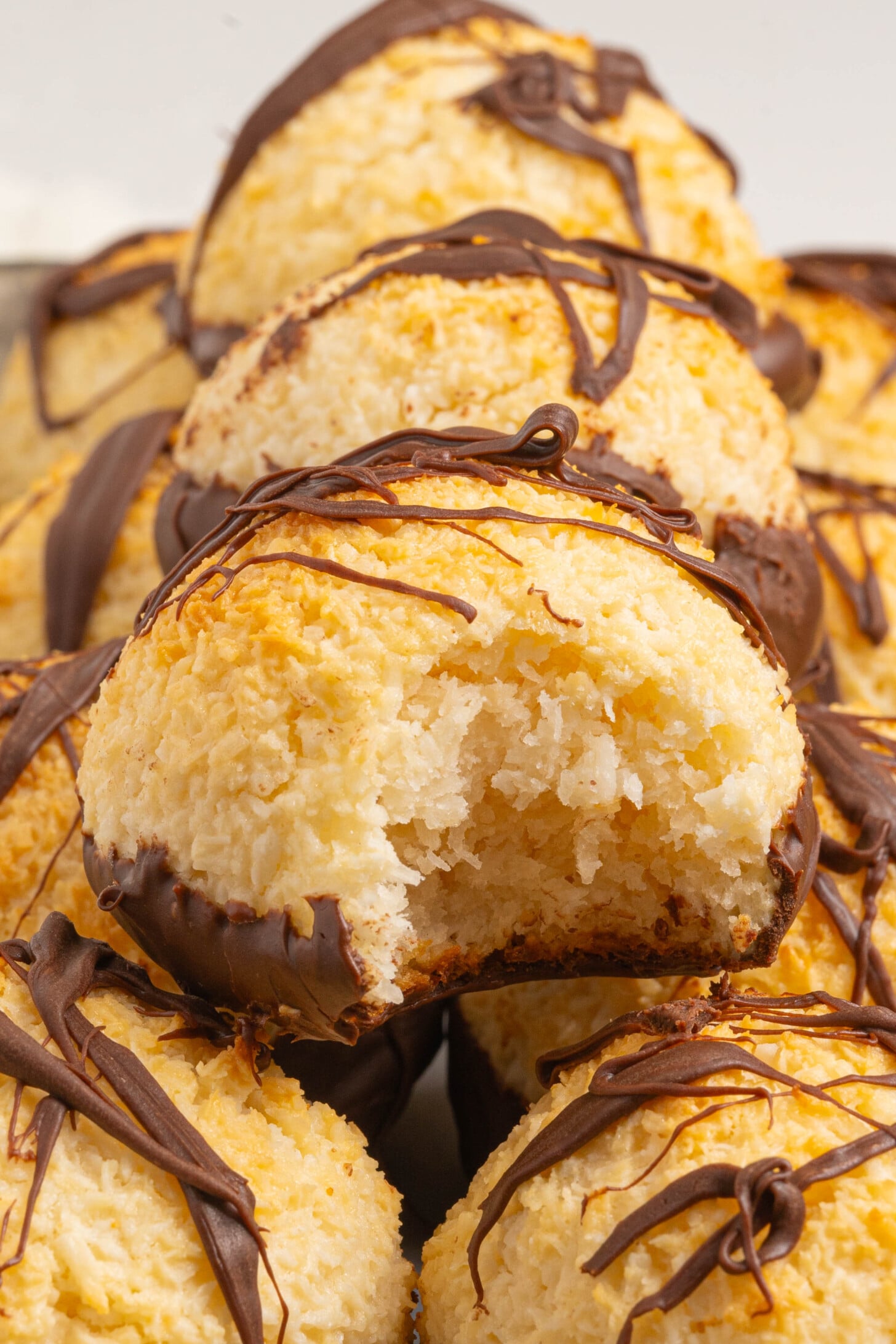 Coconut macaroons stacked on a tray.