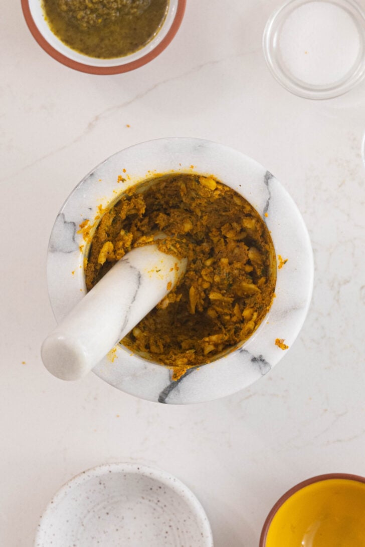 Marinade for pernil in a pilon.