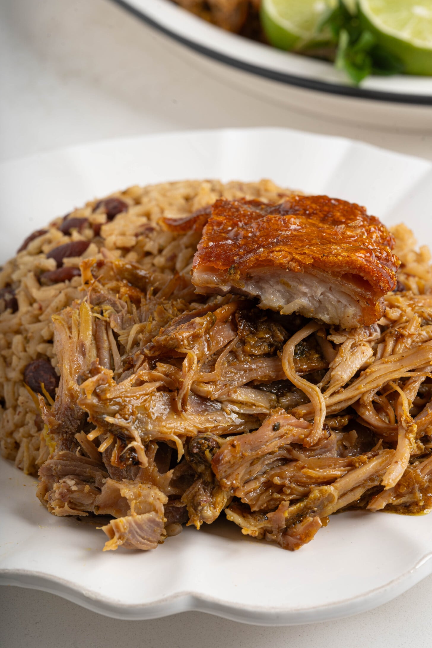A plate of rice and beans with pernil.