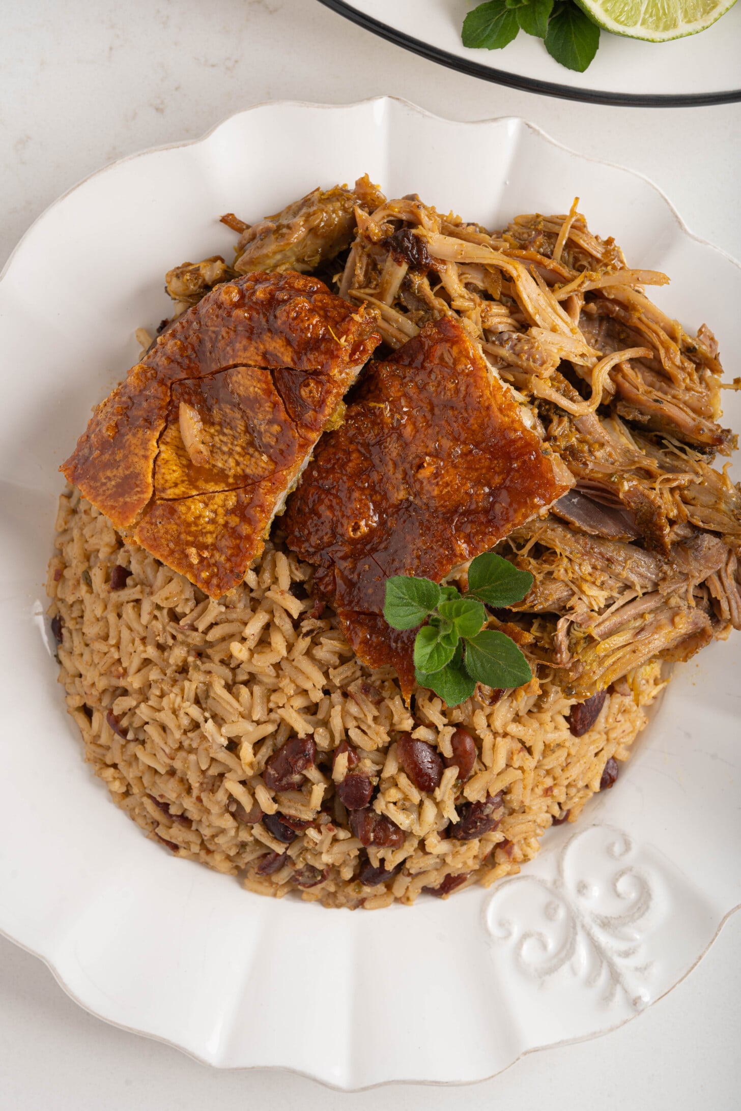 A plate of rice and beans with pernil.