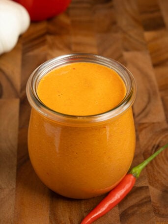A jar of mojo rojo (pepper sauce).