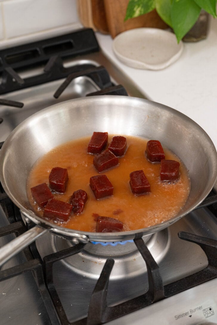 Guava paste and water in a pan.