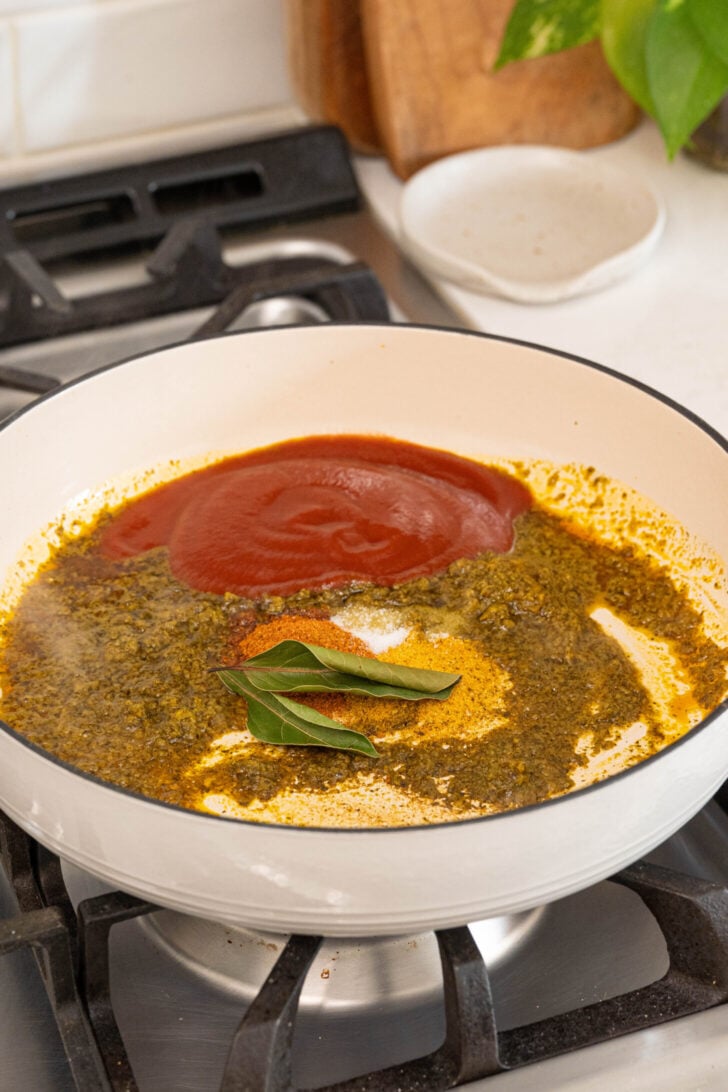 A pot with sofrito, tomato sauce, and more.