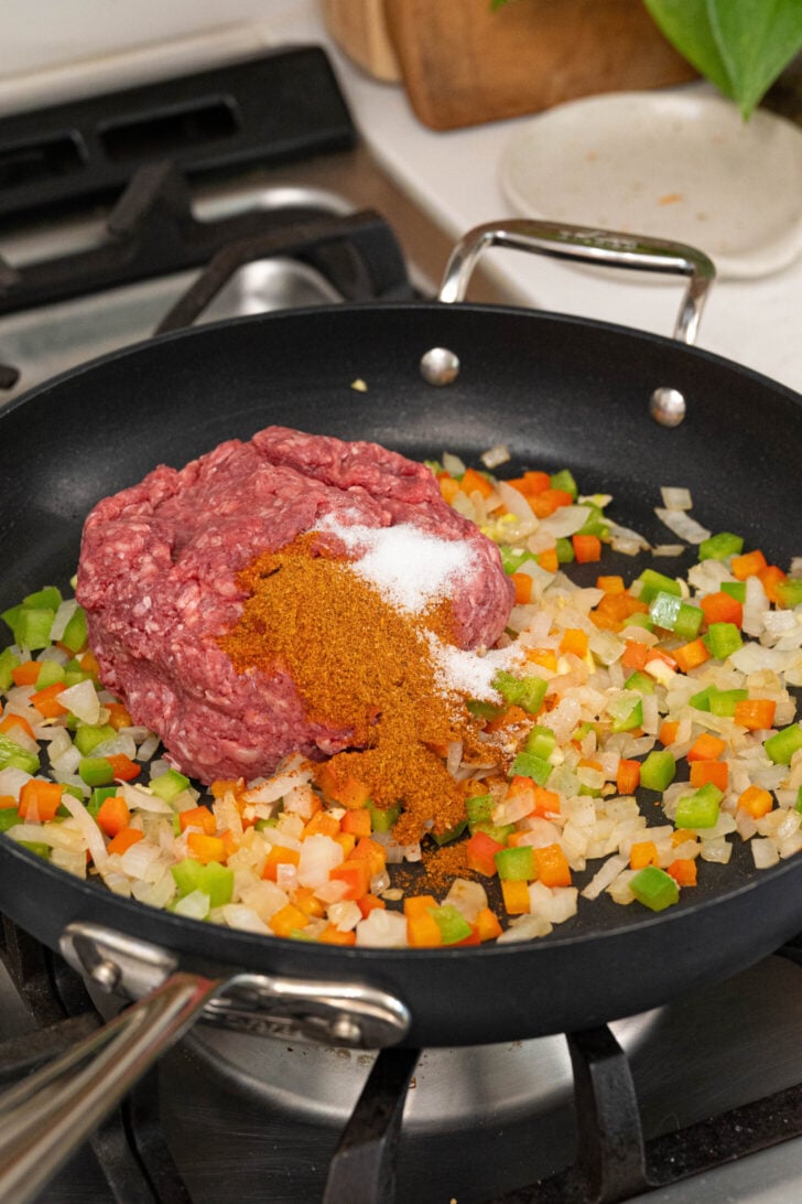 A pan with onions, peppers, ground beef and more.