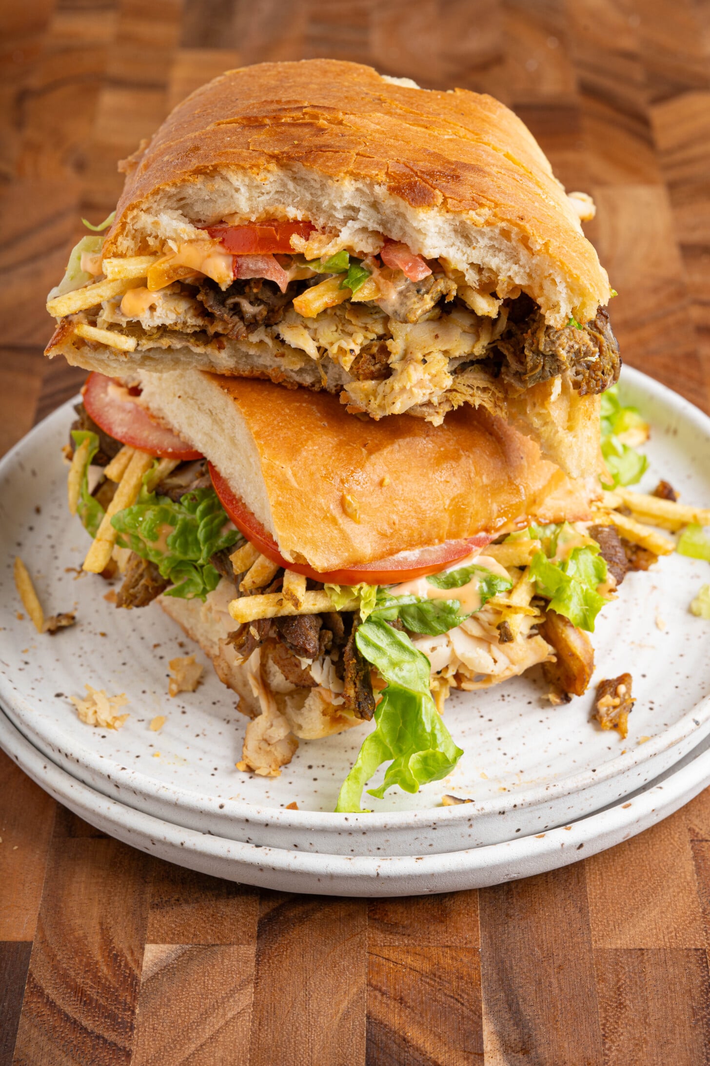 A tripleta sandwich on a plate.