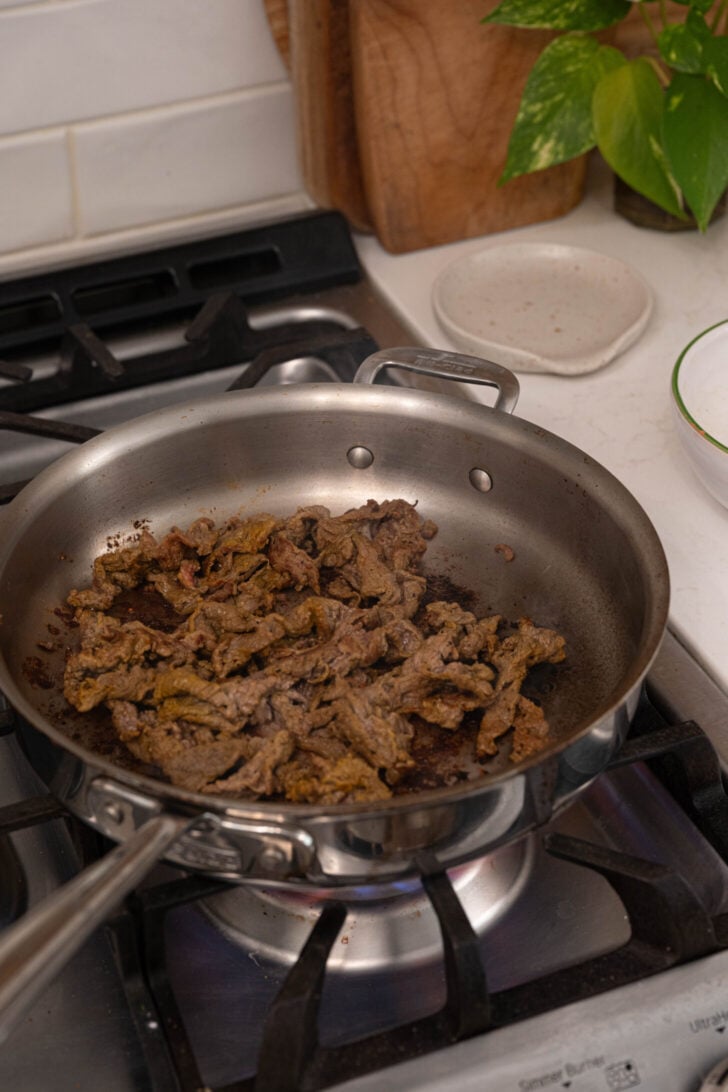 Shaved steak being cooked.