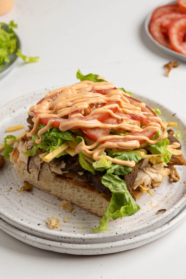 A tripleta sandwich on a plate.