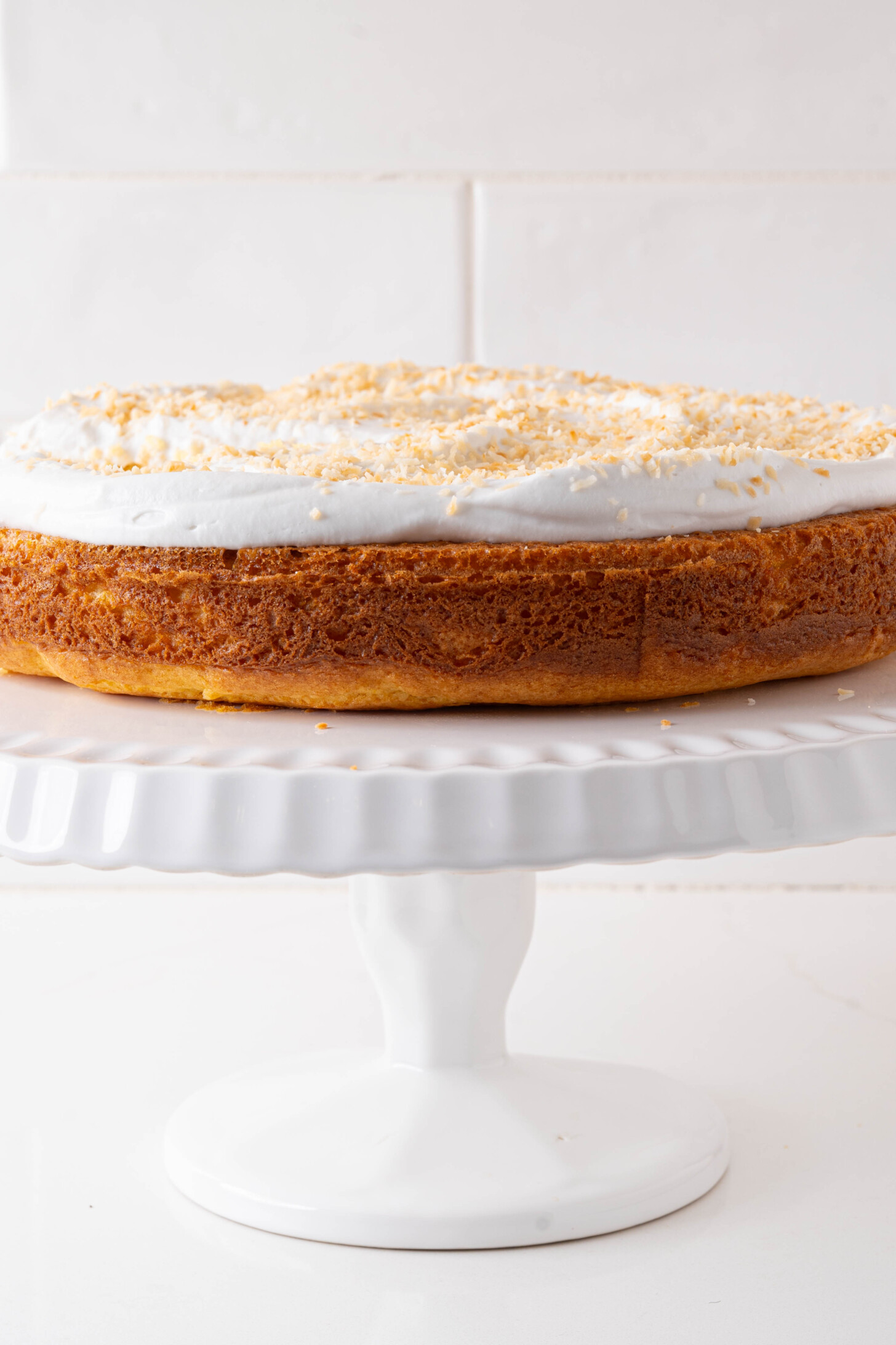 A pina colada cake on a cake stand.