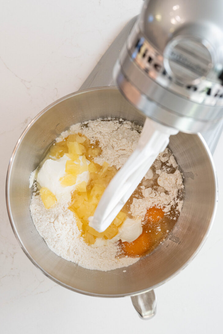 Cake batter with eggs, pineapple and more.