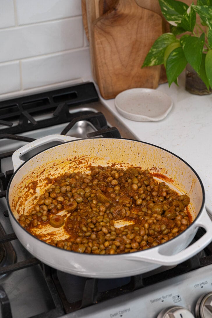 Sofrito, spices, gandules and more in a pot.